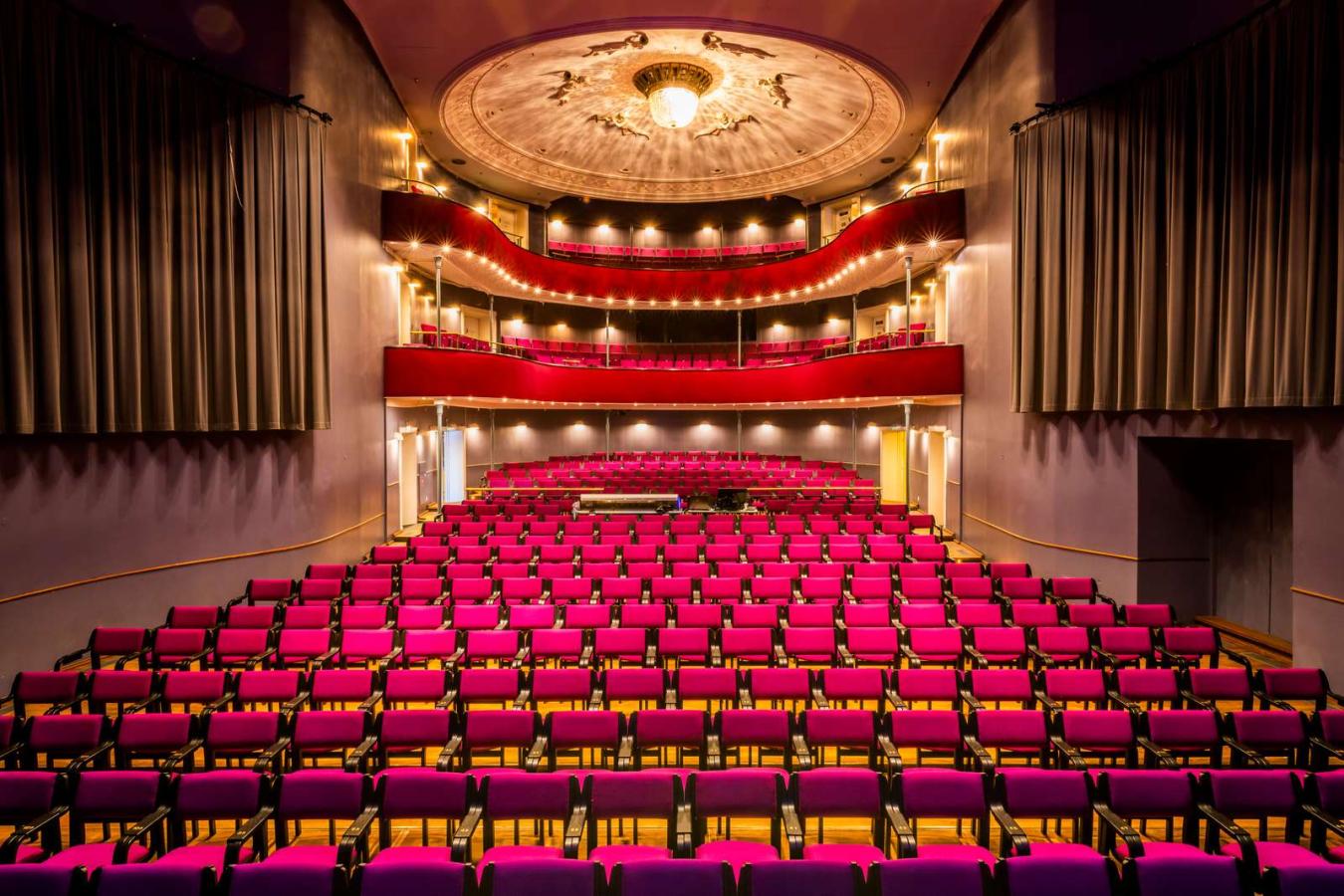 Udsigt fra scenen over flotte røde stolerækker i Horsens Ny Teater